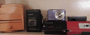 lot 141 image: Sony FM-AM pocket radio, wooden jewlery box, Casio canon 10.1  mega pixels exilin camera comes with battery charger