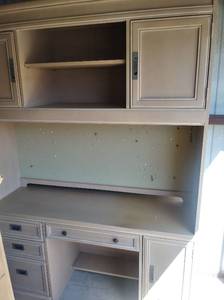 lot 20 image: 2 piece Stanley Desk Top piece has 2 tier shelving and 2 doors 49x56 x10. Bottom half 2 door 1 pull out keyboard table pull out art drawer 30x56x21. total size together 79x56x21