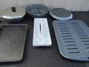 lot 151 image: Revere ware covered sauce pan, bunt cake pan, broiler pan plus lazy Susan cake plate