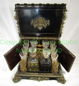 lot 5 image: Antique late 1800s casket wet bar complete with black lacquer finish and brass ormolu embellishments, 15 x 15 x 12