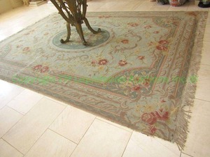 lot 20 image: Persian style area rug. Center medallion and frame border in muted colors, fringed ends, 4ft x 8ft