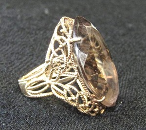 lot 412 image: 10K Smokey Topaz Marquise Shape Ring Rope Mounting High Table Design. Marked 10K Size 7