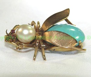 lot 419 image: 14K Gold Figural Insect BroochPin with Turquoise Body, Pearl head and Ruby eyes. Marked 14K. About 1.5L Textured Brushed Wings. Ruby eyes tested.