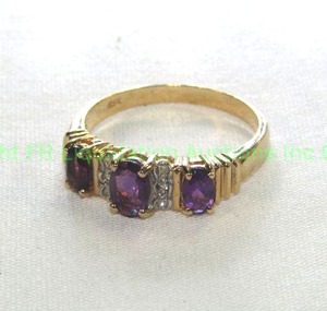 lot 434 image: 10K gold ring with Amethyst and Diamonds. Ribbed Shoulders. Size 7.25 Marked 10K and ESX Amethyst and Diamonds tested