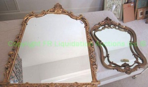 lot 595 image: Ornate giltwood framed arched mirror and Edwardian style anamorphic curvilinear form mirror, One has Carolina Mirror label. largest is 35 x 50