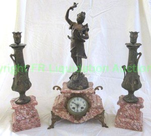 lot 632 image: Antique French Art Nouveau clock garniture set with candlesticks set upon pink striated marble. Bronze figure on top signed A. Rucho