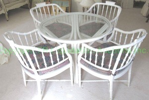 lot 638 image: Vintage white painted rattan patio set with glass top table (38 x 28.5) and 4 barrel back spindle chairs. Has seat cushions.