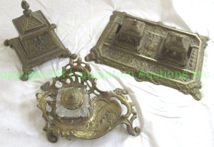 lot 640 image: Antique Brass inkwell trio. One is art nouveau style with glass inkwell. Inserts are present. As shown