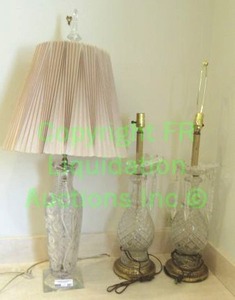 lot 587 image: Crystal lamp trio. Matched pair of brass and crystal base lamps with prisms, Crystal wheel cut lamp with crystal finial & square base, tallest is 39