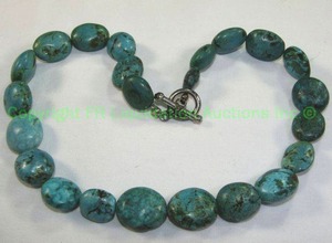 lot 548 image: Polished Oval Turquoise Bead Necklace. Unmarked.  16L