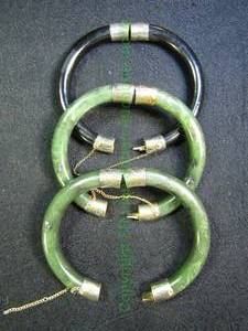 lot 617 image: Set of 3 polished stone (Jade, Black Onyx) Bangle Bracelets with safety chains and two tone metal fittings. All 3 have hidden push button releases 3 ct