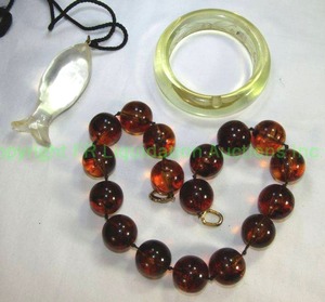 lot 622 image: 1970s era Acrylic bangle bracelet with interior etched design. Design is on interior. A true 70s piece. Also includes a signed Les Bernard Acrylic Tortoise Large Bead Necklace 18L and a vintage clear carved Acrylic Fish Pendant on cord