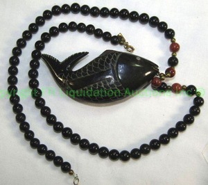lot 674 image: Black onyx and Goldstone bead necklace with carved ebony fish pendant Marked LN, 22L