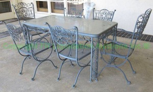lot 779 image: Vintage metal scrollwork patio table (32.5 x 60.5 x 29) and matching chairs as shown, 2 captains chairs, 4 side chairs