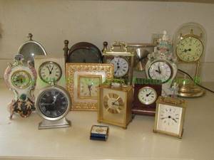 lot 210 image: Jaeger travel clock and shelf, mantle and carriage clock selection. Includes Reina Califa Cherub plus