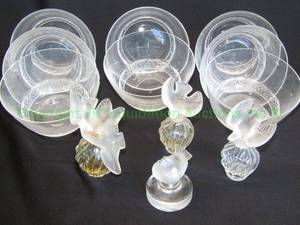 lot 308 image: Lalique dessert bowls, Nina Ricci perfume bottles and Lalique Finch paper weight grouping as shown, all marked