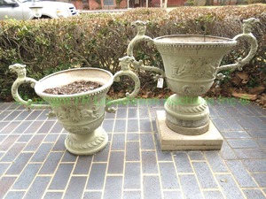 lot 774 image: Pair of decorative metal planters with cherub panel friezes and exaggerated mythological gryphon handles, Heavy, tallest is 24