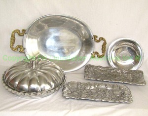 lot 384 image: Polished pewter and aluminum serving ware including Nambe