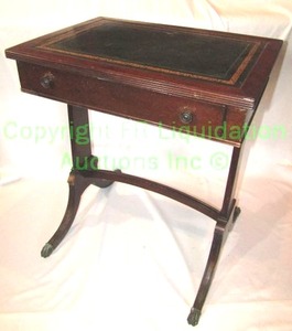 lot 748 image: Vintage campaign style writing desk with green leather and gold stenciled top, splayed legs with brass feet, arched stretcher, 23 x 17 x 26