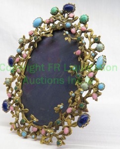 lot 817 image: Art nouveau glass jeweled encrusted portrait frame in foliage form. Wood frame easel back.