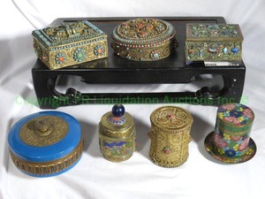 lot 399 image: Nepalese and other brass prayer boxes on rosewood stand. Includes ornamented turquoise and coral decorated, enamel work plus