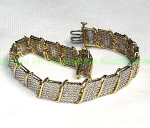 lot 784 image: 10K yellow gold and diamond multi row tennis bracelet w S-links, safety clasp (marked 10K 5ct JWBR, diamonds tested)