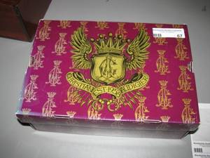 lot 67 image: New in the box Christian Audigier shoes - $149.00 price tag