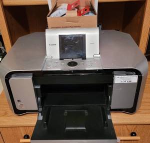 lot 197 image: CANON MP970 PRINTER WITH EXTRA INK CARTRIDGES AS SHOWN. THIS UNIT IS STILL PLUGGED IN.