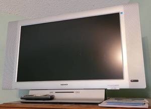lot 203 image: MAGNAVOX TV WITH REMOTE CONTROL AND MANUAL AS SHOWN. THIS UNIT IS STILL PLUGGED IN.