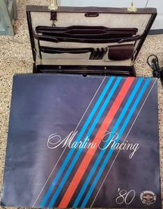 lot 324 image: BRIEFCASE PLUS LARGE SIZE VINTAGE 1980 RACING CALENDAR AS SHOWN.