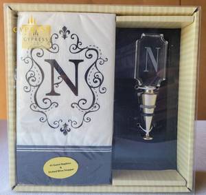 lot 167 image: ETCHED WINE STOPPER WITH N MONOGRAM AND GUEST NAPKINS IN UNOPENED PACKAGE.