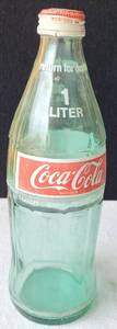 lot 227 image: VINTAGE COCA-COLA 1-LITTLE GLASS BOTTLE WITH ORIGINAL CAP AS SHOWN.