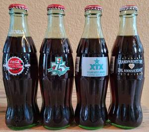 lot 240 image: LOT OF 4 COCA-COLA UNOPENED COMMEMORATIVE COLLECTIBLE BOTTLES AS SHOWN.
