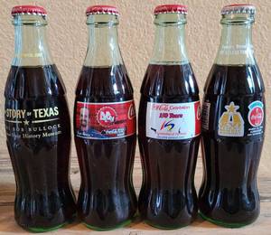 lot 241 image: LOT OF 4 COCA-COLA UNOPENED COMMEMORATIVE COLLECTIBLE BOTTLES AS SHOWN.
