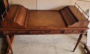 lot 123 image: VINTAGE HERITAGE WOODEN DESK WITH LEATHER INLAY TOP AND TWO ROLL TOP STYLE TAMBOUR STORAGE AREAS AS SHOWN. APPROX. 57 W x 27 D x 37 H. CHECK IT OUT