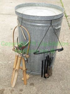 lot 139 image: Galvanized metal garbage can and wind chimes