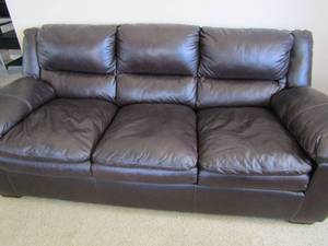 lot 113 image: Ashley Furniture Company brown leather stitched pillow back sofa