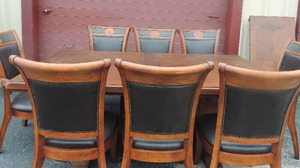 lot 14 image: Walnut double pedestal dining room table with corner accents and extension leaf and matching leather upholstered chairs with hobnail trim (2 captain, 6 side chairs)