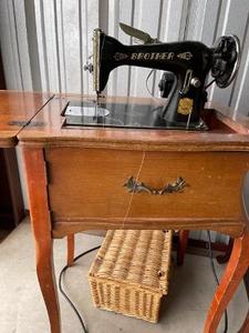 lot 219 image: Vintage Brothers sewing machine in self store cabinet and Nippon machine (Made in Occupied Japan) Plus sewing bench and notions