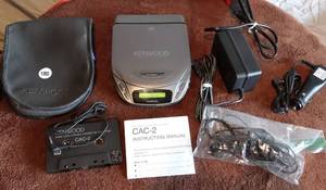lot 180 image: VINTAGE KENWOOD CD WALKMAN WITH CASSETTE ATTACHMENT AND CABLES IN STORAGE BAG - WORKING