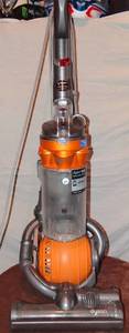 lot 311 image: Dyson DC25 Multi Floor Bagless Upright Vacuum Cleaner Orange - TESTEDSUCKS IN A GOOD WAY