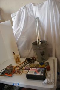 lot 87 image: Metal Shelf Brackets, Radial Tire Chains, Chevy Repair Manuals, Hydraulic Jack Oil and Tools