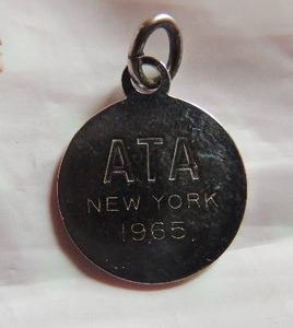 lot 172 image: Tiffany charm ATA 1965 New York STERLING  Dime size
