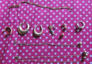 lot 154 image: Gold lot 10K TW 18 grams. Shrimp style hoop earrings - one small one larg p, golf charm with sapphire, 3 ball studs engraved bracelet 3 ball necklace pearl drop necklace and ring setting