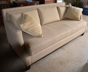 lot 16 image: Beige Couch, removable cushions, riveted trim (78W x 38D x 34 T)