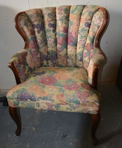 lot 37 image: Queen Anne Wing Back Chair highlighted by the upholstered Floral channel back and accented with the contoured wood trimmings