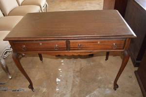 lot 4 image: Antique Ribbon Mahogany Writing Table with Dual Front Drawers, Cabriole style legs and Wheels