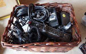 lot 184 image: LARGE WICKER TOTE FILLED WITH POWER SUPPLY, AUDIO, HDMI, AND OTHER CABLES
