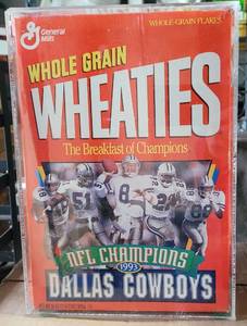 lot 241 image: 1993 COLLECTIBLE DALLAS COWBOYS SUPER BOWL CHAMPS WHEATIES CEREAL BOX IN ACRYLIC PROTECTOR AS SHOWN. BOX APPEARS TO BE FULL AND UNOPENED.