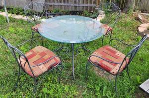 lot 377 image: WROUGHT IRON PATIO TABLE WITH GLASS TOP AND FOUR CHAIRS AS SHOWN. (YOUR BID X 5)